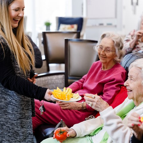 The Ridglea | Seniors getting handed a snack by a caregiver