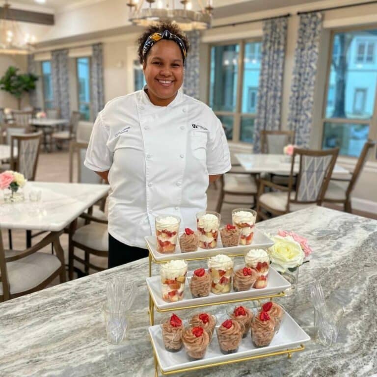 The Ridglea | Chef smiling behind dessert items