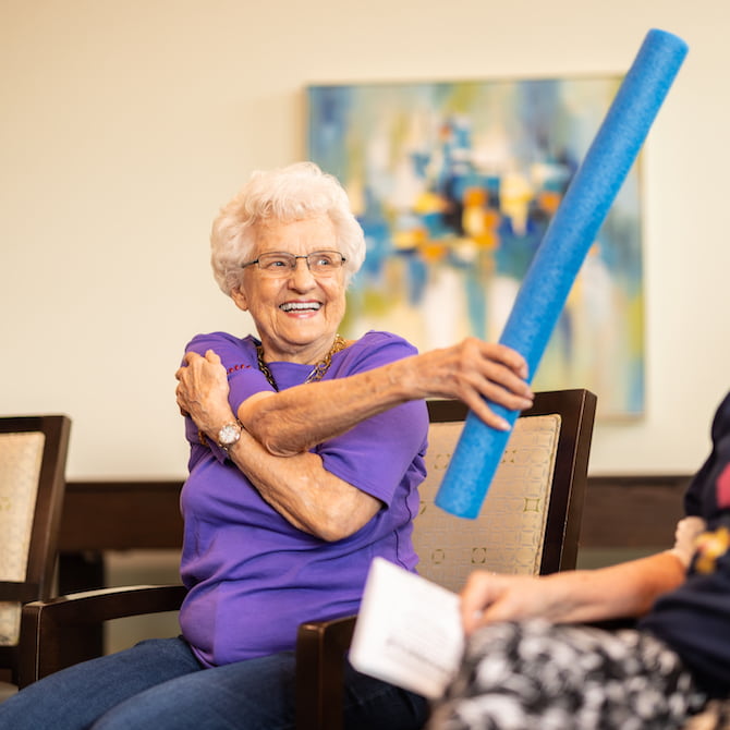 Civitas Senior Living | Memory care residents stretching and laughing