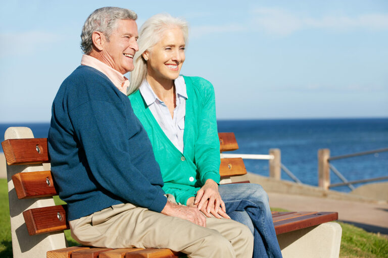 The Waters of Cape Coral | Senior couple sitting on a bench looking at the view