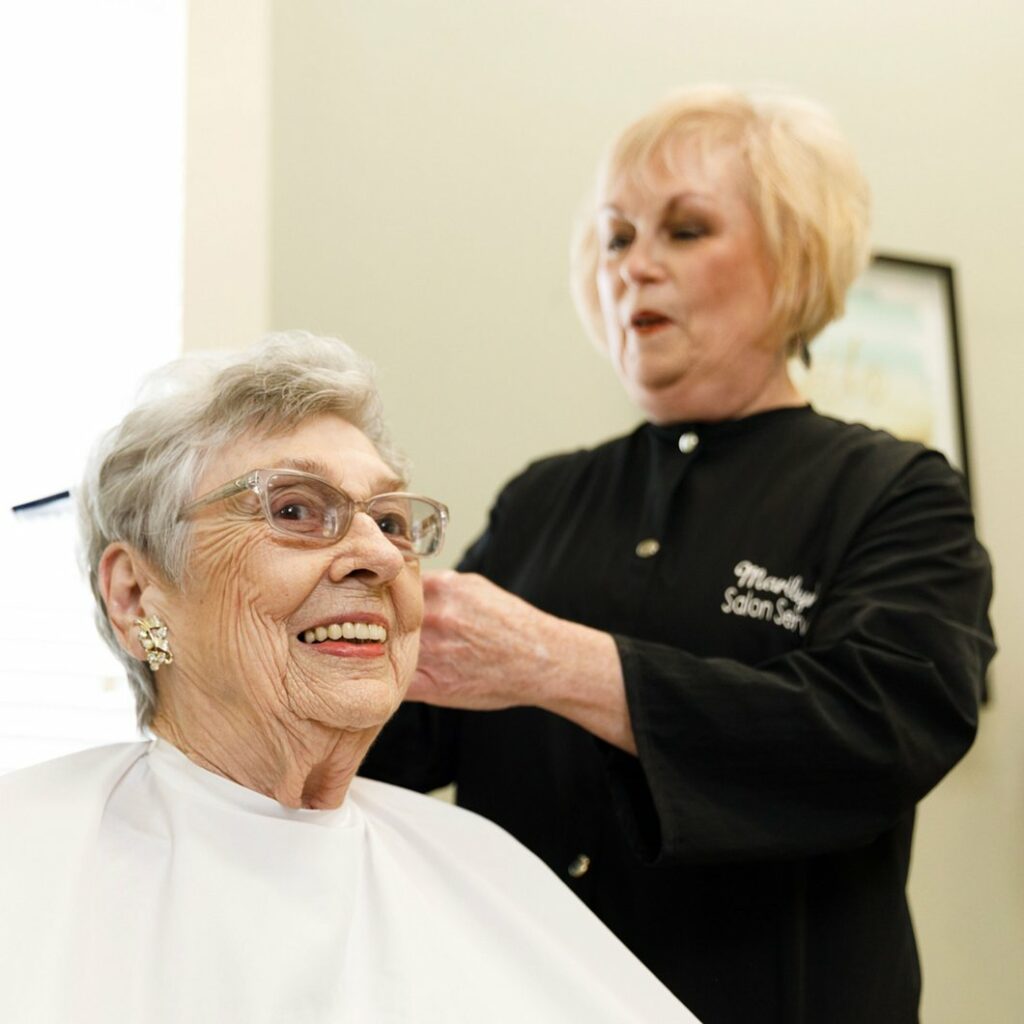 Valley View Senior Living | Senior woman getting a haircut by hairdresser