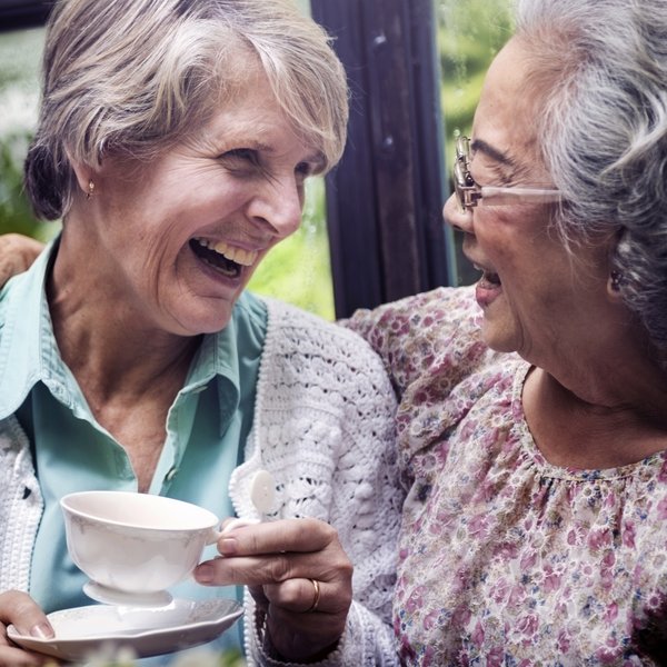 Valley View Senior Living | Senior women drinking tea smiling at each other