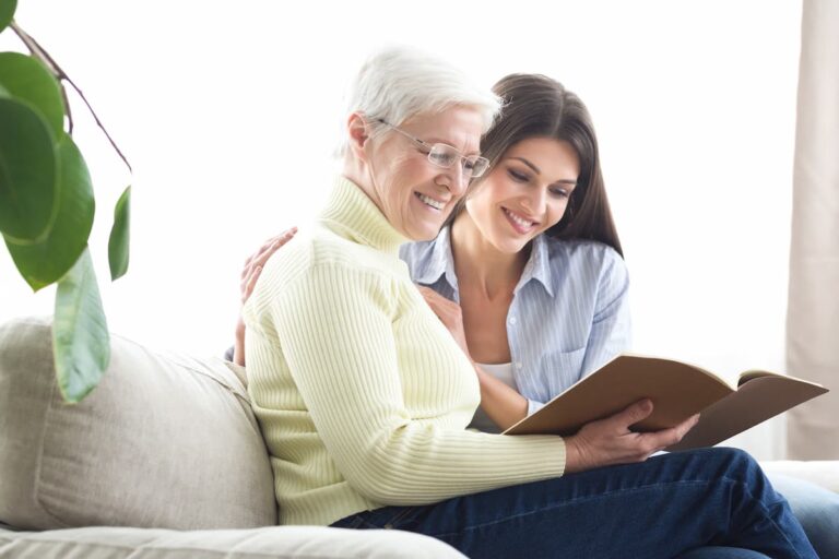 Valley View | Senior woman with caregiver reading a book together