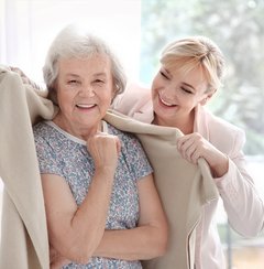 Civitas Senior Living | Caregiver putting a blanket on a senior