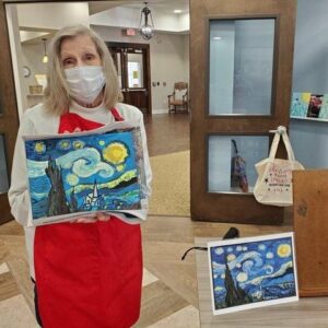 Civitas Senior Living | Resident holding her "Starry Night" painting