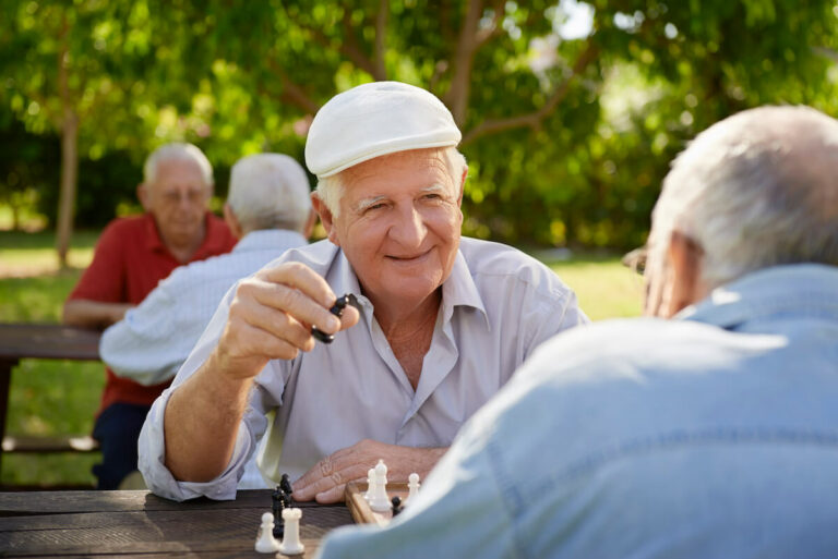 Double Creek | Active retired seniors, two old men playing chess at park
