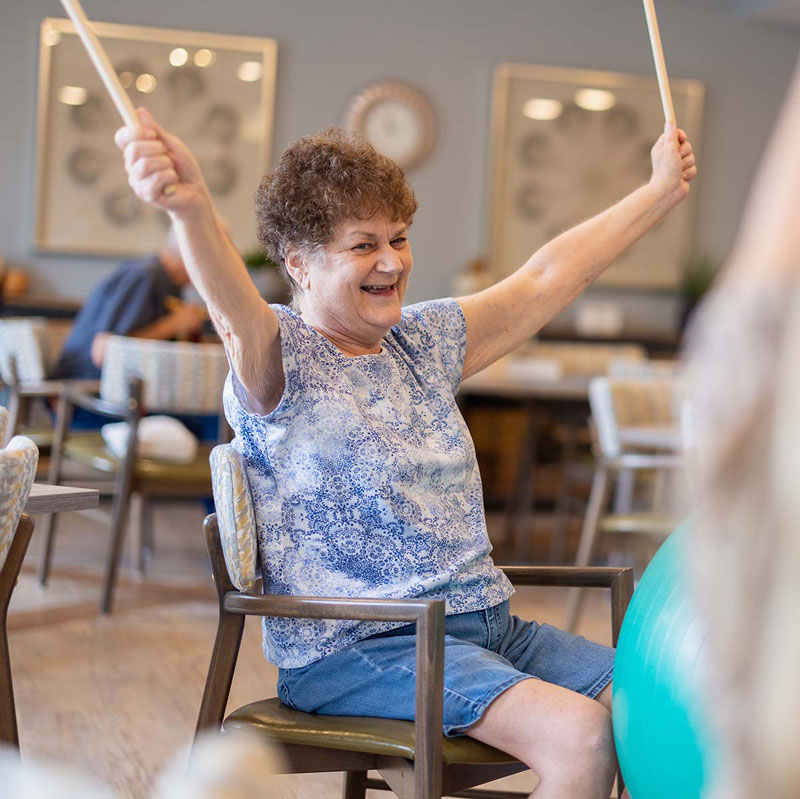Civitas Senior Living | Senior woman playing with drumsticks