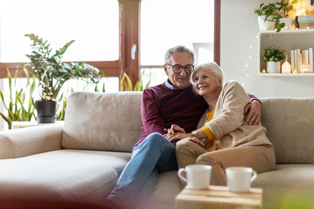 Ariel Pointe of Sachse | Senior couple sitting on couch in their apartment