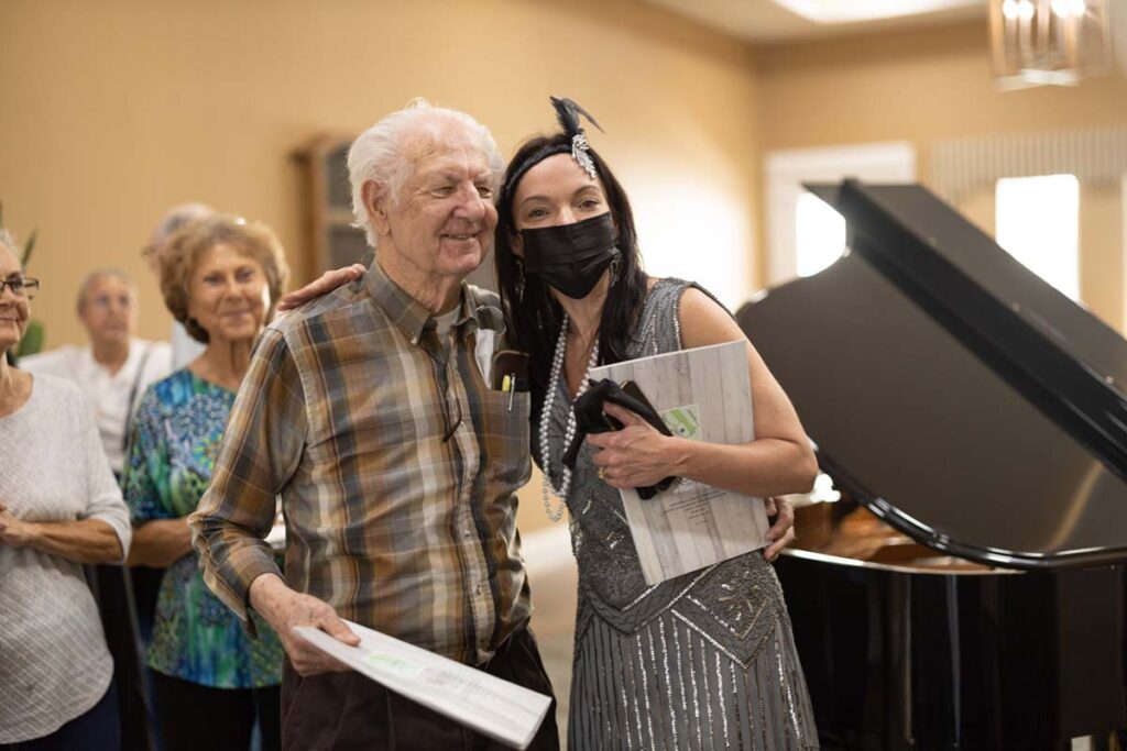 The Brooks of Cibolo | Senior man posing for a picture with woman dressed like the 20s