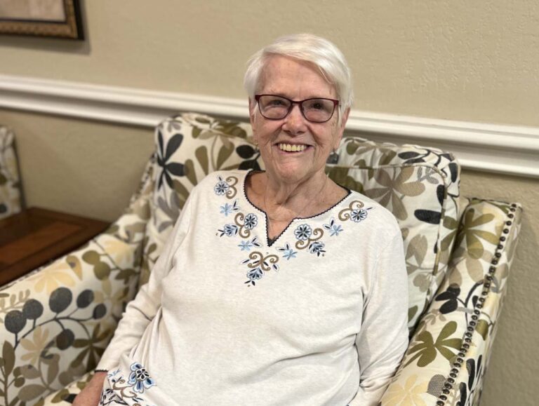 Valley View | Resident, Bea sitting in a chair at an event