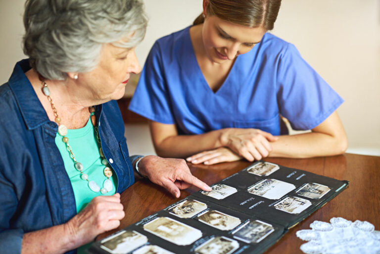 Legacy Oaks of Azle | Senior woman sharing photos with nurse