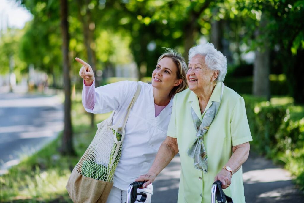 Elan Westpointe | New Braunfels mobility - senior woman with caregiver walking outside