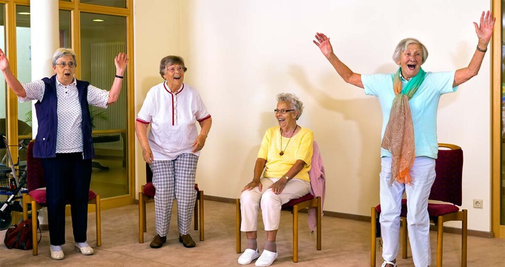 The Bluffs of Flagstaff | Flagstaff care homes | Senior women standing and sitting for exercise