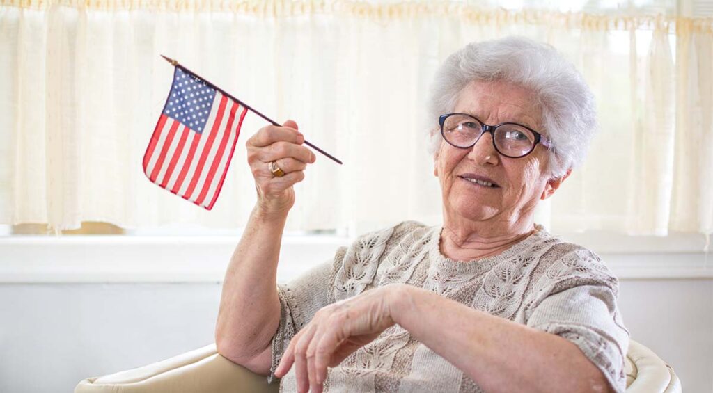 Double Creek | Senior woman holding a minature American flag
