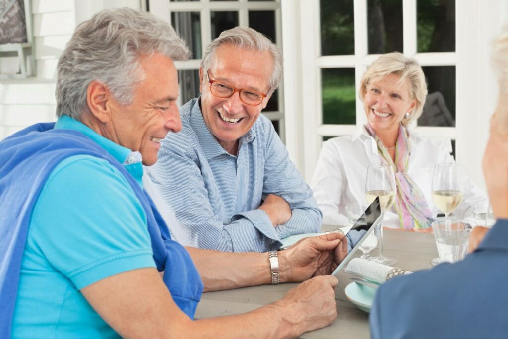 Avenues of Fort Bend | Seniors smiling looking at a tablet