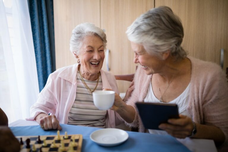 The Grand | Senior women laughing while drinking coffee