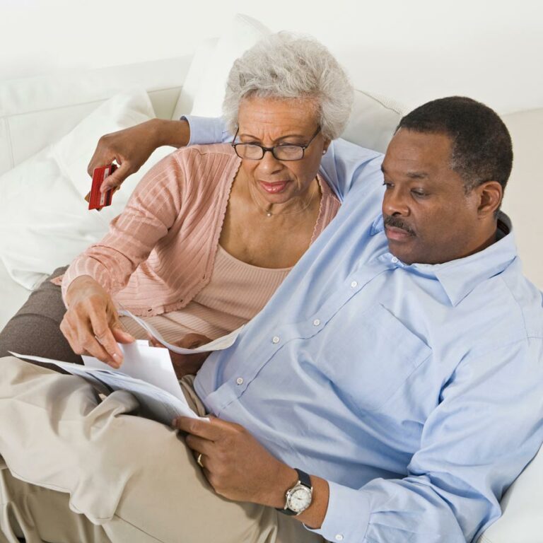 Civitas Senior Living | Senior couple looking at book together on couch