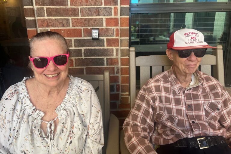 Double Creek Assisted Living | Retired couple sitting outside their apartment