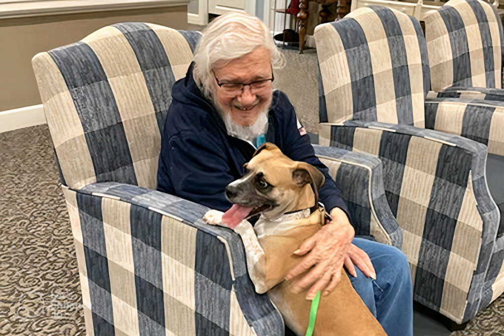 The Grandview of Chisholm Trail | Senior petting his dog