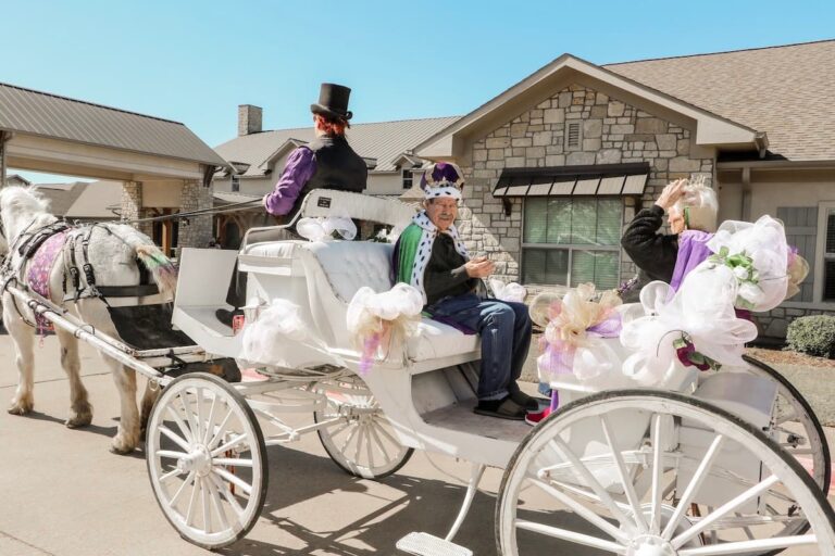 Arabella of Athens | Two senior community residents riding in a horse drawn carriage