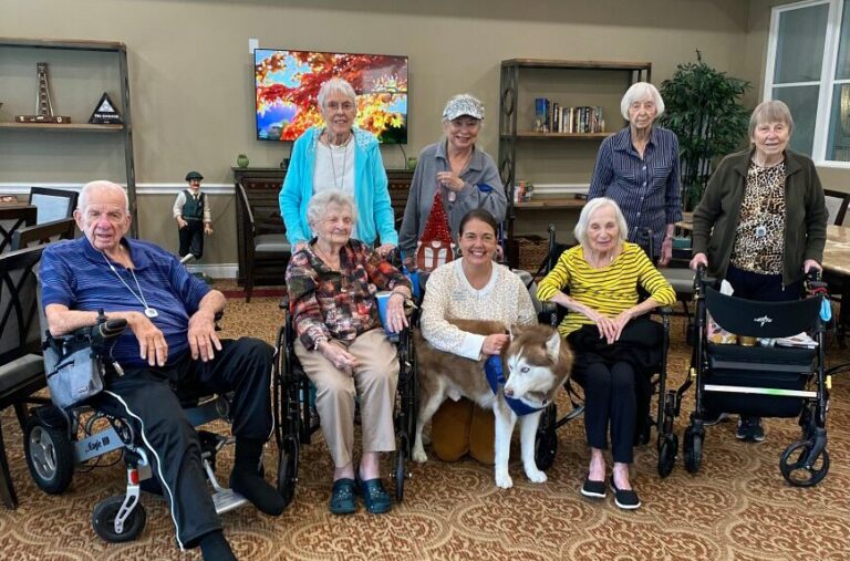 The Ridglea | Senior resdients with a therapy dog