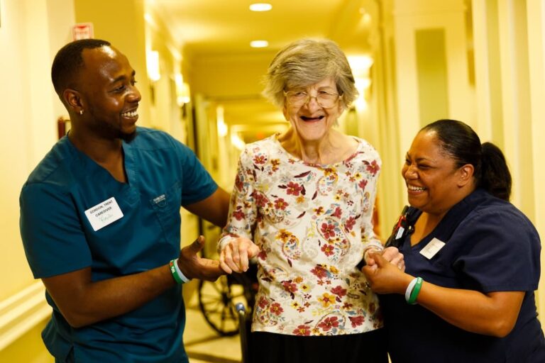 Civitas Senior Living | Caregivers helping a resident walk