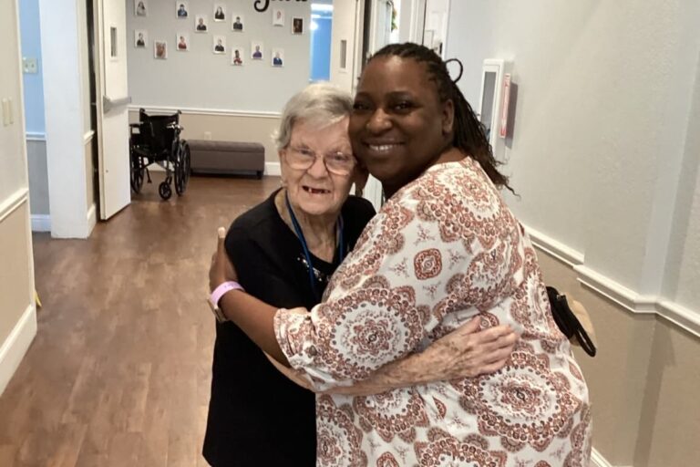Cambridge Court | Senior and team member hugging