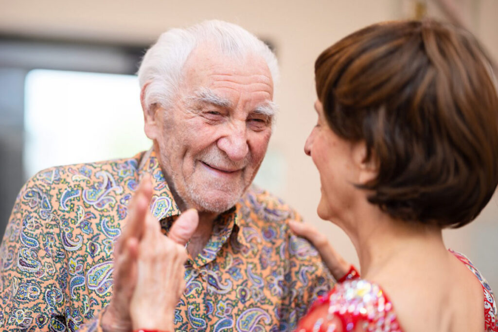 Senior man embracing caregiver