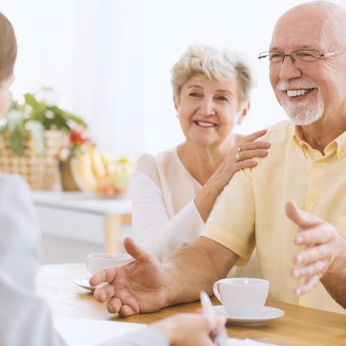 Civitas Senior Living | Happy senior couple talking to a professional about senior living