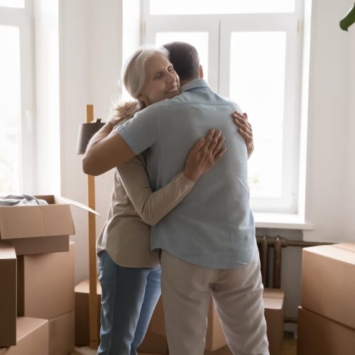 Civitas Senior Living | Senior woman hugging her son in a room surrounded by boxes