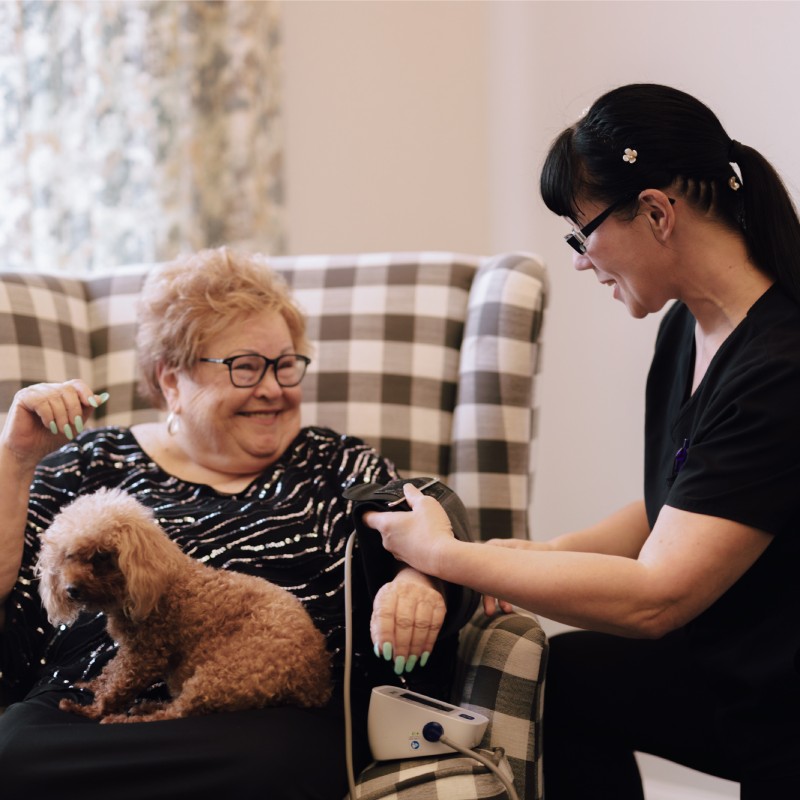 Caregiver giving routine medical attention to resident