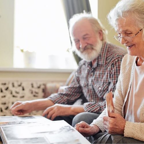 Alexis Pointe of Wimberley | Senior couple looking through a phot album on the coffee table