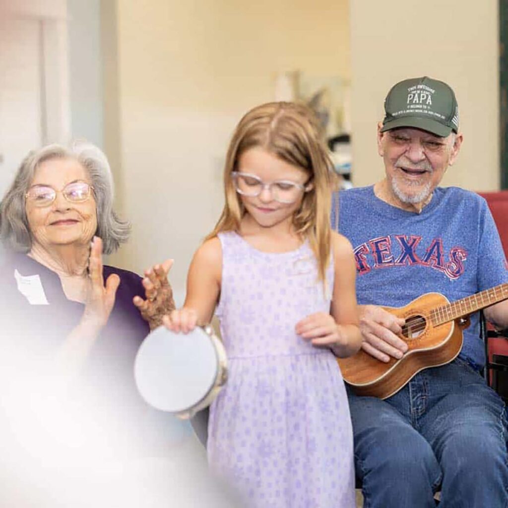 Senior couple playing music with their grandchild
