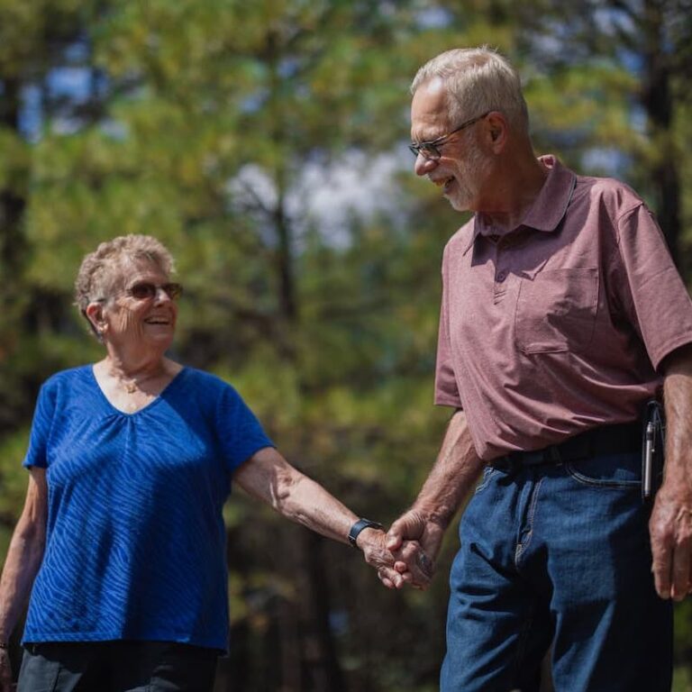Cambridge Court | Senior man and woman holding hands walking outdoors