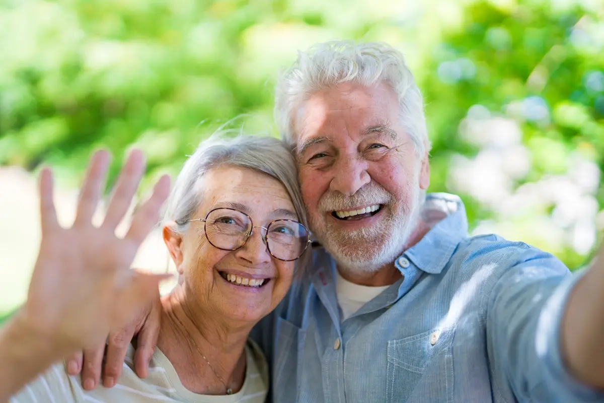 A happy senior couple take a close, affectionate selfie