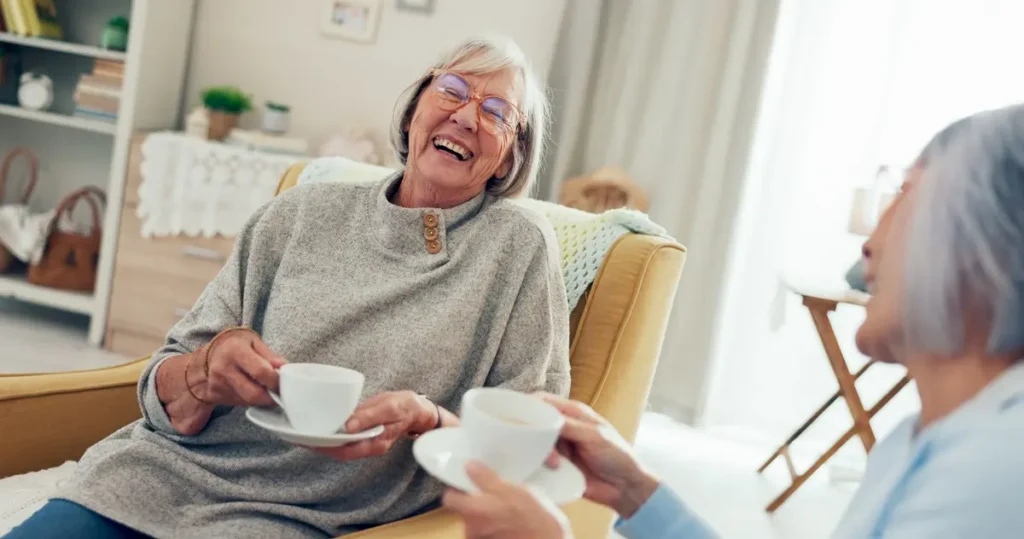 Senior women, friends laughing with coffee