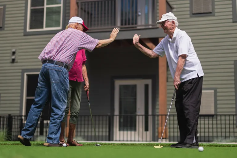Civitas Senior Living | Seniors celebrating while playing golf together