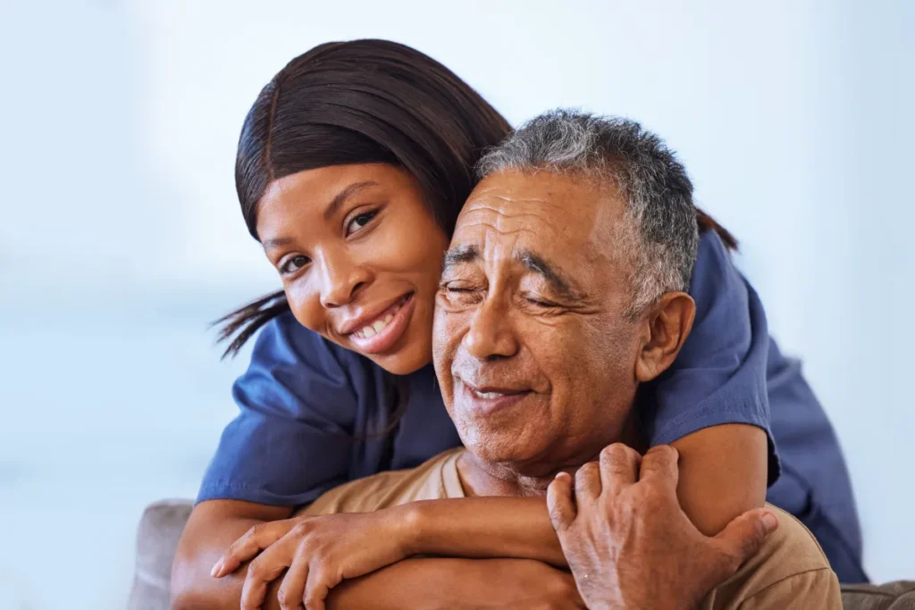 Caregiver embracing senior resident