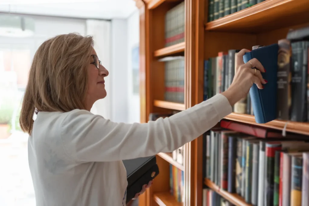 Senior woman shelving books and volunteering