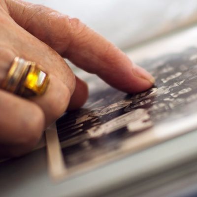 The Avenues of Fort Bend | Senior pointing at old photo