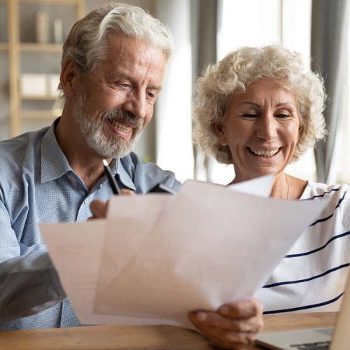 Civitas Senior Living | Senior couple use online banking on laptop planning family budget