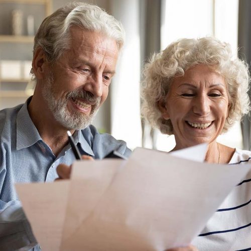 Civitas Senior Living | Senior couple use online banking on laptop planning family budget