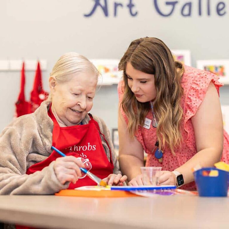 Civitas Senior Living | Senior resident painting with caregiver