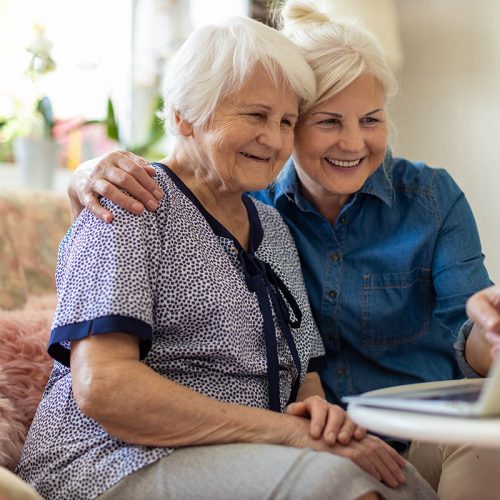 Autumn Wind | Two senior women looking at laptop