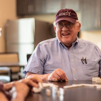 Senior residents laughing and playing a game