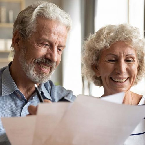 Civitas Senior Living | Senior couple use online banking on laptop planning family budget